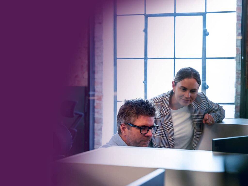 Two people looking at a computer screen