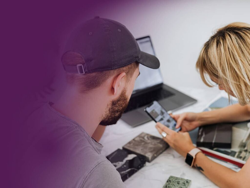 Two people looking at a phone screen