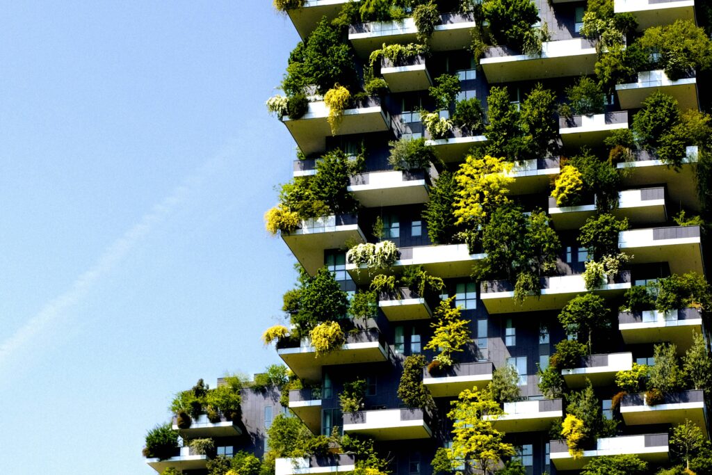 Close-up of a high-rise building with extensive greenery on balconies.