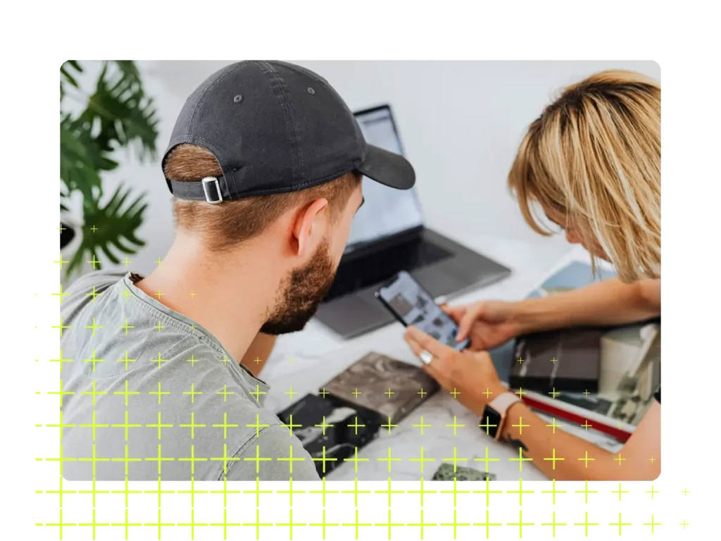 Two people looking at a phone