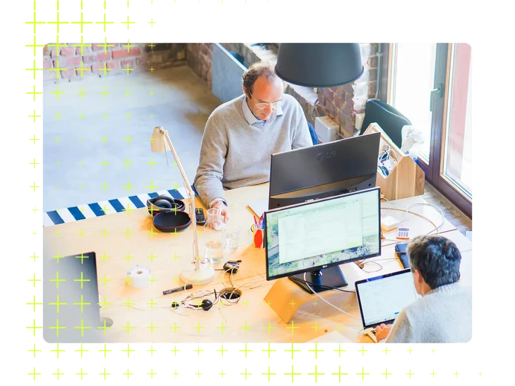 Overhead shot of two men at their desks